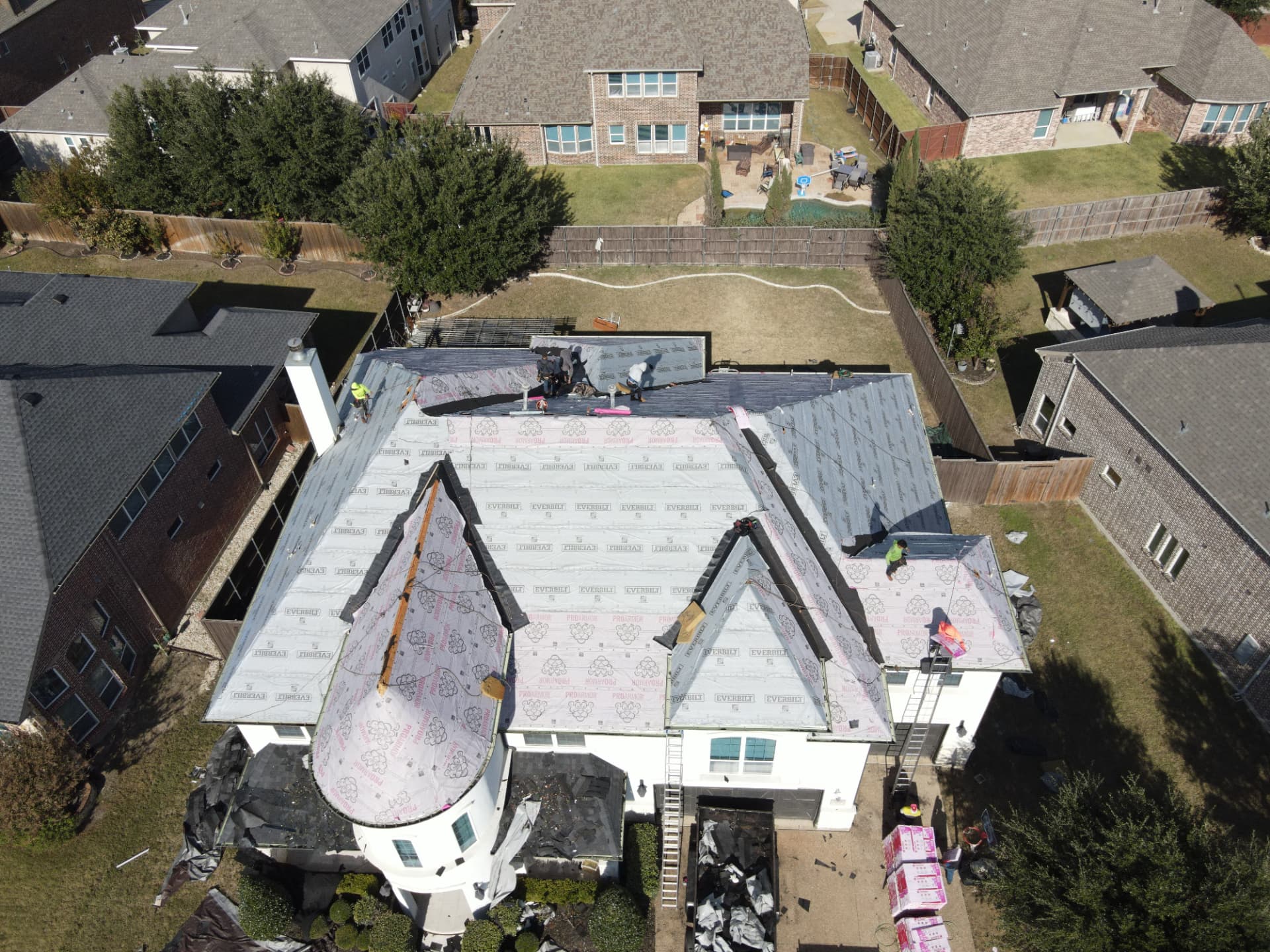 Aerial view of an Ascent crew working on a residential roof